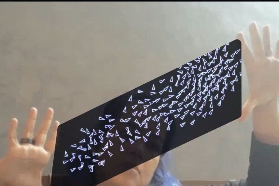 A dark window held open and tilted between two spread hands, paper-plane fireflies crowding one end of it