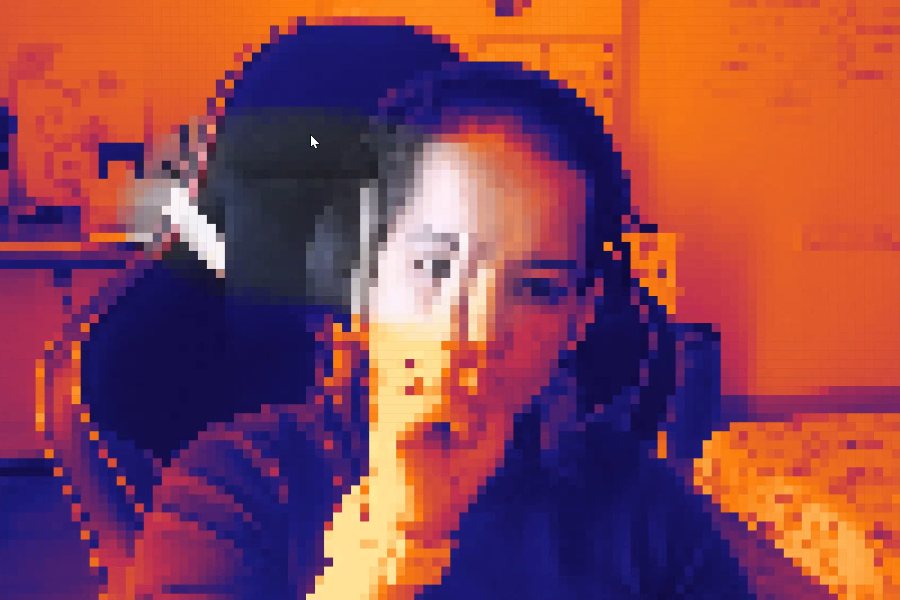 Divya in the pixel mirror, her face and raised hand rebuilt in hot orange and deep blue